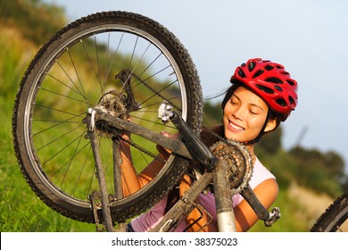 Bike Repair. Woman Repairing Mountain Bike. Beautiful Smiling Woman.