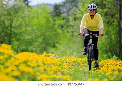 Bike riding - woman on bike, healthy lifestyle concept