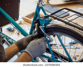 at the bike shop store and repair , old caucasian mechanic expert repairs assembling cargo bicycle