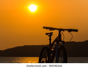 Bike and Sun set in orange background.