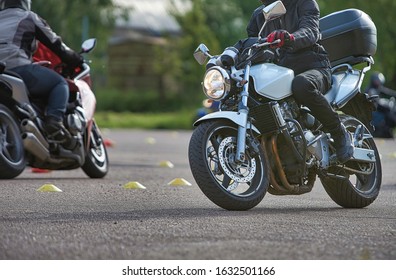 The biker in action or movement, riding around a curve road.