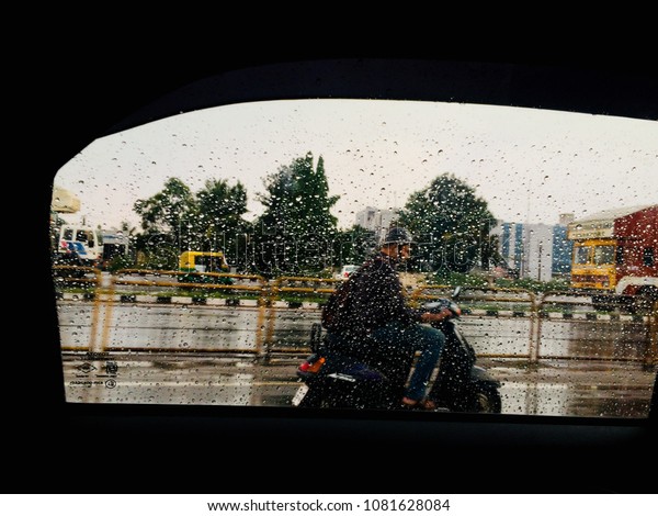 A biker is biking on a wet road
isolated raindrops on a cars window glass unique
photo