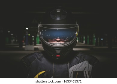 Biker in black helmet close up portrait.