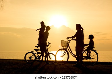 Biker Family Silhouette , Family On The Beach At Sunset.