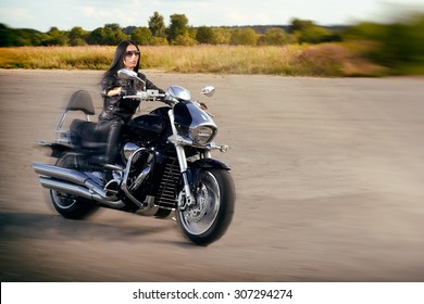 Biker Girl In Leather Jacket Riding On A Motorcycle.