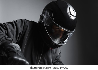 Biker in the helmet close up portrait, riding motorcycle, studio shot