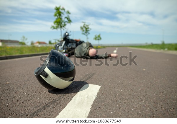 biker
helmet lies on street near a motorcycle
accident