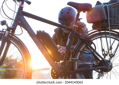 biker inserting electric bike battery