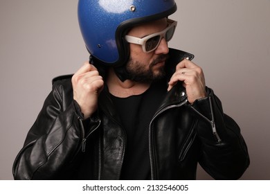 Biker Man Posing In Leather Jacket And Blue Motorcycle Helmet. Isolated.