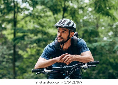 Biker Man Resting During Riding The Bike In The Mountain. Male Athlete In Cycling Gear Practising Outside On Nature Background. Travel And Extreme Sport Concept.