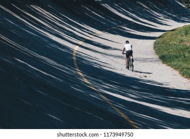 Biker With Mountain Bike Along Path In Old Racetrack, Speedway Parabolic In The Autodrome Of Monza - Lombardy - Italy