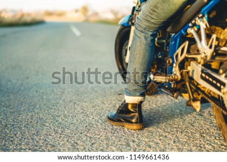 Similar – Couple sitting over motorcycle ready to go