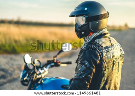 Similar – Senior man steering motorcycle on road