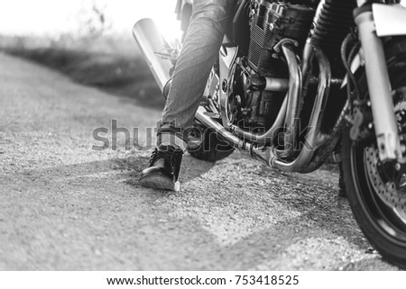 Similar – Couple sitting over motorcycle ready to go