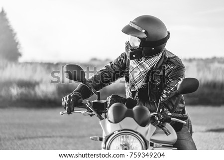 Similar – Senior man steering motorcycle on road