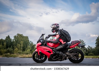 Biker On A Sports Bike Red, Riding On The Road