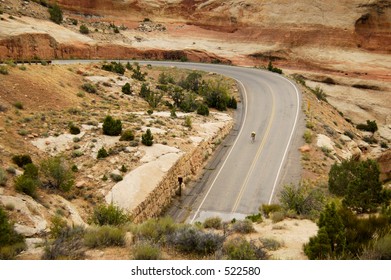 Biker On A Winding Road Through The Colorado National Monument.