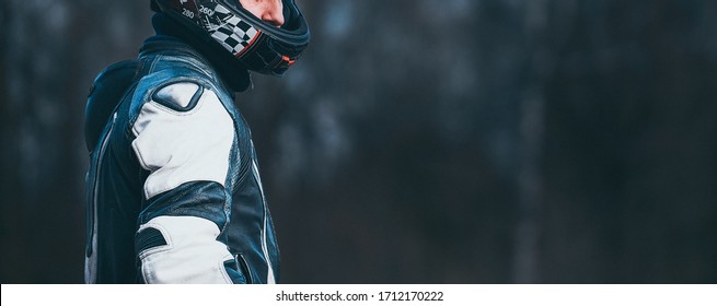Biker in protective suit with a helmet.