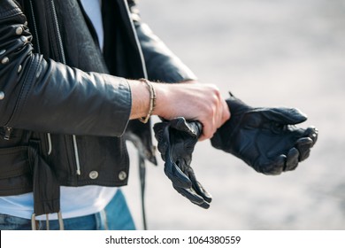 Biker Putting On Leather Gloves To Drive His Motorbike