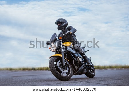 biker rides motorcycle, turns, bright colors motorcycle, sports fast motorcycle