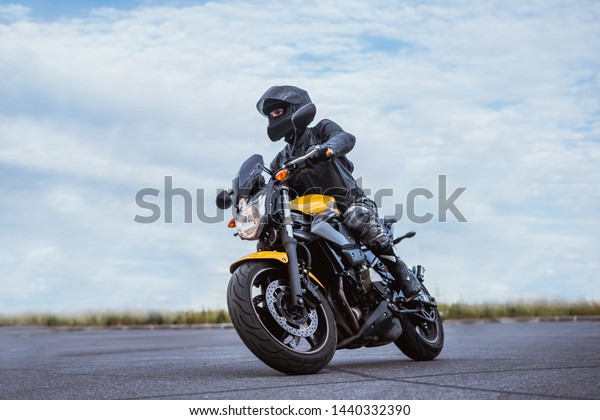 biker rides motorcycle, turns, bright colors\
motorcycle, sports fast\
motorcycle