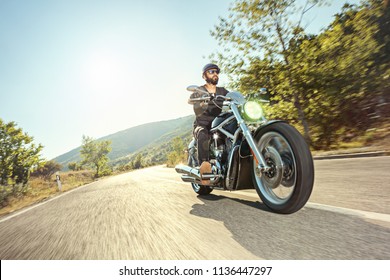 Biker Riding A Motorcycle On Open Road