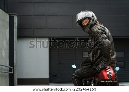 Biker sitting on a motorcycle and looking back