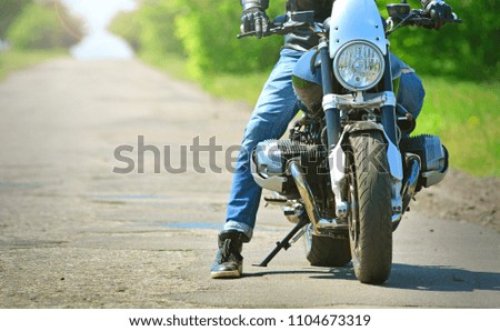 Couple sitting over motorcycle ready to go