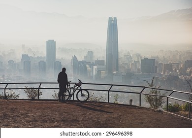 Biker At The Top Of The City. Santiago De Chile Cityscape.