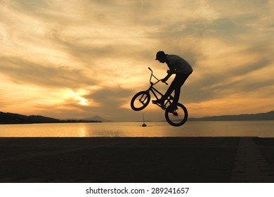 Biker tricks against the sunset. - Powered by Shutterstock