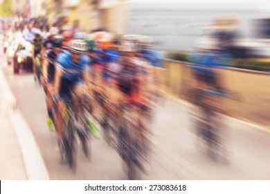 Bikers During Bike Race On City Street, Radial Blurred Zoom With Vintage Instagram Look Added In Post Processing