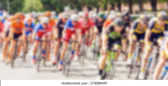 Bikers During Bike Race On City Street, Defocusing Effect With Vintage Instagram Look Added In Post Processing