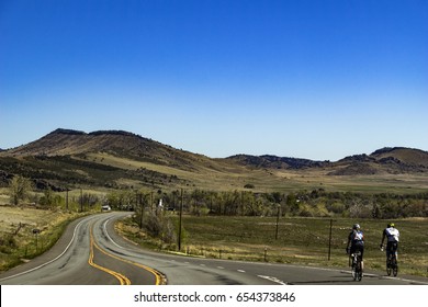 Bikers On A Road Along The Rocky Mountains Foothills Near Boulder / Colorado / USA