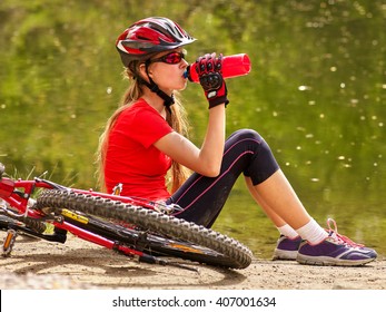 Bikes Cycling Girl Wearing Helmet. Girl Cycling Drinking Of Bottle Water.