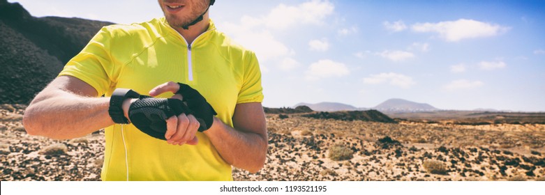 Biking Cyclist On Mountain Bike Using Wearable Tech Device Smart Watch On Outdoor Training. Panoramic Banner Man Athlete Active Lifestyle.