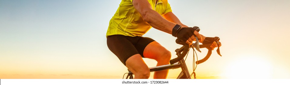 Biking Cyclist Riding Road Bike With Smartwatch Athlete Training At Sunset Outdoor Cycling. Sport Smart Watch Fitness.