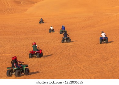 Biking Dubai Adventure Tour –Tourists Having Fun On Bike Riding In Dunes Of Dubai. Dune Bashing And Dune Buggy Activities