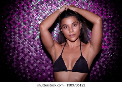 Bikini babe in front of purple tiles, portrait