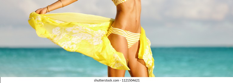 Bikini woman with yellow scarf unveiling toned slim thighs and body. Spa wellness free happy girl in bikini weight loss healthy living concept. Panorama banner.