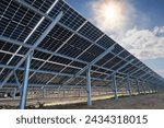 Bilateral solar panels, photovoltaics? with natural sun flare - alternative source of electricity, concept of sustainable and renewable resources. Panoramic backwards view.