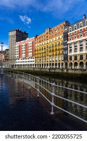 BILBAO, SPAIN - FEBRUARY 14, 2022: Ribera Del Nervión Area With The Bailen Skyscraper And The Railway Station Reflected On The Water In The City Of Bilbao , Basque Country, Spain.