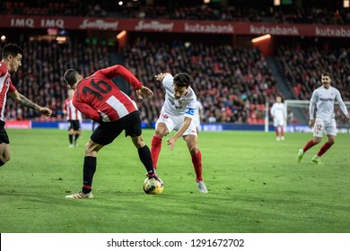 BILBAO, SPAIN - JANUARY 13, 2019: Jesus Navas (R) and Dani Garcia (L) dispute the bal during a Spanish League match between Athletic Club Bilbao and Sevilla FC at San Mames Stadium