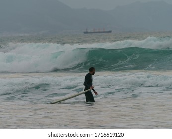 Bilbao, Spain - June 8, 2019:: Water Splashes Around Surfer Going To Epic Barrel Wave. Extreme Pro Sportsman Surfing A Wave In Basque Autonomous Community In Summer Cloudy Day