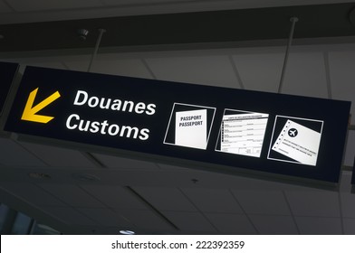 Bilingual Customs And Passport Control Sign At International Airport.