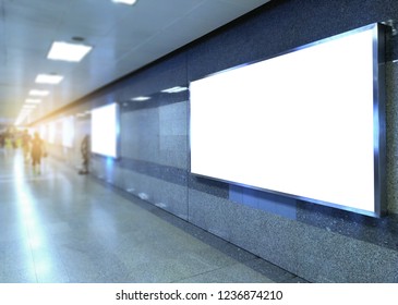 billboard big blank white LED screen perspective horizontal outstanding in subway side pathway people walking to train underground for display advertisement text template promotion new brand indoor.