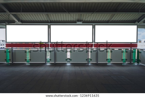 billboard big blank white\
three LED screen horizontal outstanding at side way people walking\
on sky train for display advertisement text template promotion new\
brand indoor.