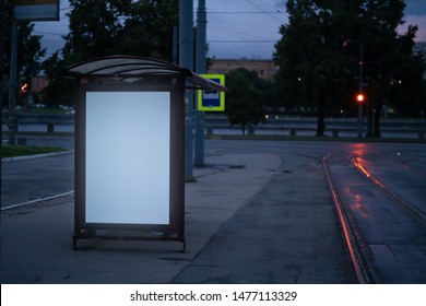 Billboard At The Bus Stop Outdoor Ad.glowing At Night In The City Bus Shelter With White Field Mockup Advertisement.