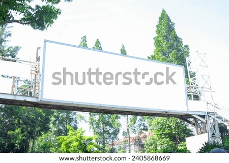 Billboard mockup on the wall of a pedestrian bridge with an empty outdoor advertising screen