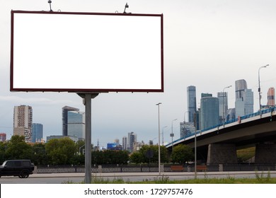 Billboard on the background of the city and the bridge. Mock-up.