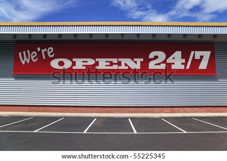 Billboard on a retail building with notice saying  We're open 24/7